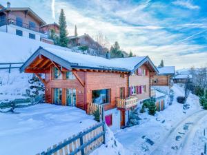 a log cabin in the snow with a fence at Chalet La Balance by Interhome in Nendaz