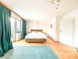 a white bedroom with a bed and a blue rug at Villa Acereto by Interhome in Nassereith