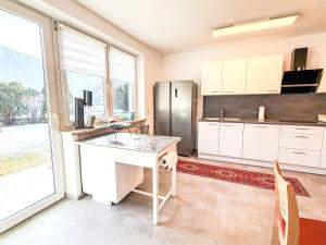 a kitchen with a desk and a refrigerator at Villa Acereto by Interhome in Nassereith +28 photos