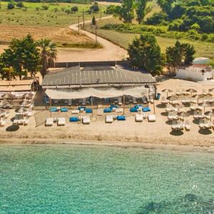 a group of chairs and umbrellas on a beach at Villa Maria in Elani