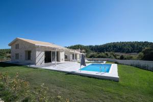 a stone house with a swimming pool in a yard at Villa Maria in Elani