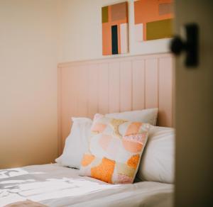 a bed with two pillows on top of it at Hazel House Ballarat in Wendouree
