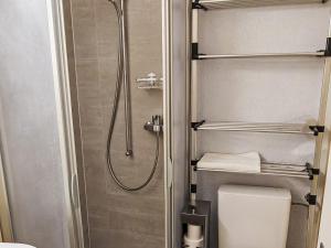 a bathroom with a toilet and a shower in it at Apartment Studio Turmalin by Interhome in Leukerbad