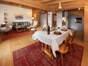 a dining room and living room with a table at Apartment Ker Eol by Interhome in Villars-sur-Ollon
