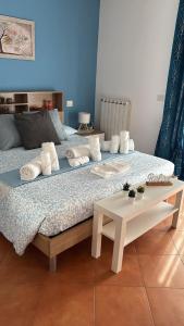 a bed with pillows and a table in a room at Casa Vacanze Palidoro Il Plumbaco in Palidoro