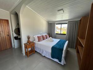a bedroom with a large bed and a window at Casa Prado in Prado