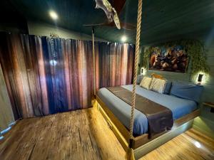 a bedroom with a swing bed in a room at "Squirrels Gone Wild" Luxury Treehouse Adventure Near Dollywood & Pigeon Forge in Sevierville