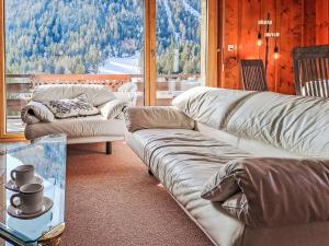 a living room with two couches and a large window at Apartment Le Sporting by Interhome in Champex