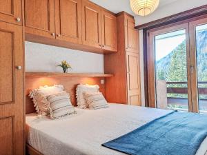 a bedroom with a bed with a large window at Apartment Le Sporting by Interhome in Champex +26 photos