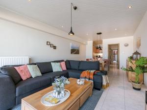 a living room with a couch and a table at Apartment Trondjhem with seaview by Interhome in Bruges +23 photos