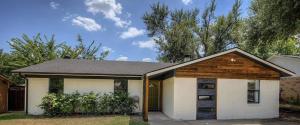 a small white house with a wooden roof at 5 Star Stay Large Remodeled Modern 4BR Near UNT and TWU Sleeps 10 in Denton