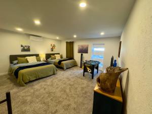 a large room with two beds and a couch at 5 Star Stay Large Remodeled Modern 4BR Near UNT and TWU Sleeps 10 in Denton