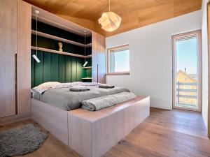 a bedroom with a large bed with a wooden headboard at Chalet Popcorn by Interhome in Abertamy