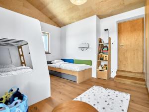 a bedroom with two beds and a door at Chalet Popcorn by Interhome in Abertamy