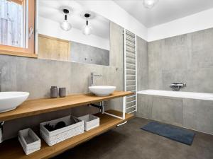 a bathroom with two sinks and a tub at Chalet Popcorn by Interhome in Abertamy