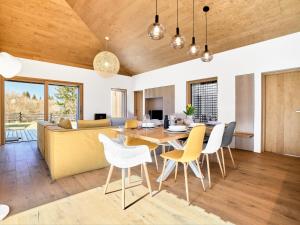 a dining room and living room with a table and chairs at Chalet Popcorn by Interhome in Abertamy +22 photos