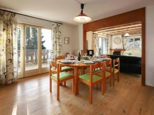 a dining room with a wooden table and chairs at Apartment Regina D1 by Interhome in Arveyes