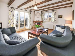 a living room with two couches and a table at Apartment Regina D1 by Interhome in Arveyes