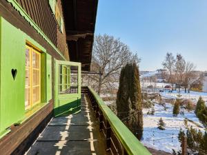 a green house with a window on the side of it at Villa Švýcarka by Interhome in Mladé Buky +47 photos