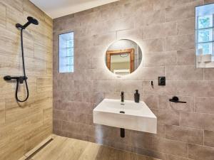 a bathroom with a sink and a mirror at Villa Švýcarka by Interhome in Mladé Buky