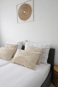 a white bed with pillows on top of it at Bootanica Apartament Piła in Piła