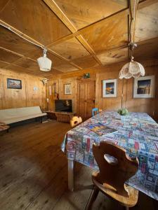 a dining room with a table in a wooden room at Vicinanza d'Andraz in Andraz