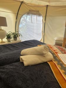 a group of towels on a bed in a tent at Gränna Glamping in Gränna