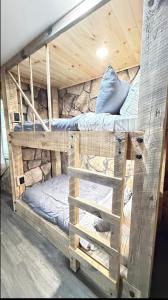 two bunk beds in a room with a pillow at cozy cabin in Dalton
