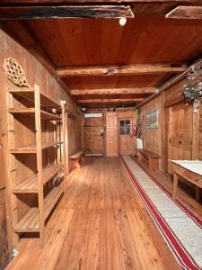 an empty room with wooden floors and wooden walls at Vicinanza d'Andraz in Andraz