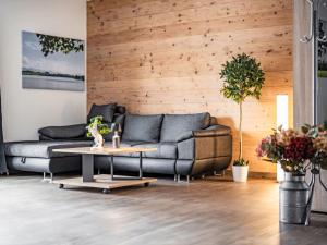 a living room with a couch and a table at Apartment Alpenlodge Breitenberg by Interhome in Lechbruck