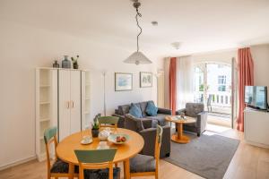 a living room with a table and a couch at Strandhaus Belvedere in Binz