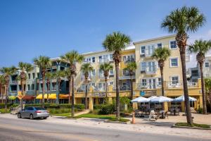 a building with palm trees in front of a street at Blue in Santa Rosa Beach