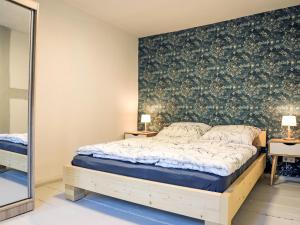a bedroom with a large bed and a mirror at Apartment Das königliche Quartier by Interhome in Mirow