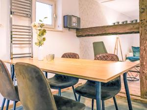 a dining room with a wooden table and chairs at Apartment Das königliche Quartier by Interhome in Mirow