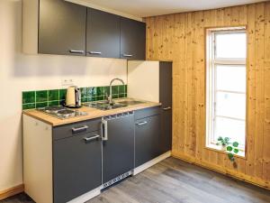 a kitchen with gray cabinets and a sink and a window at Apartment Das königliche Quartier by Interhome in Mirow +31 photos