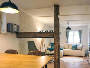 a living room with a loft bed and a table at Apartment Das königliche Quartier by Interhome in Mirow