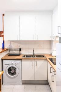 a kitchen with a sink and a washing machine at Apartment Salina by Interhome in Llança +12 photos