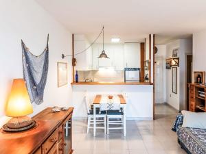 a kitchen and living room with a table and a couch at Apartment Salina by Interhome in Llança