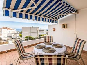 a table and chairs on a balcony with a view of the ocean at Apartment Salina by Interhome in Llança