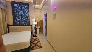 a small room with a bed and a hallway at Buddha Premium Stays in Guwahati