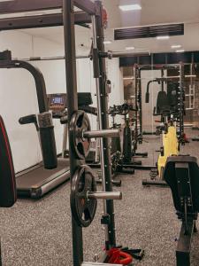 a gym with several rows of tread machines at Torre U kooliving in Manizales