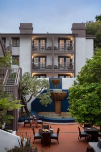 a building with a fountain in front of it at Hotel Pacific in Monterey