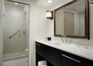 a bathroom with a sink and a shower and a mirror at Hotel Pacific in Monterey +17 photos