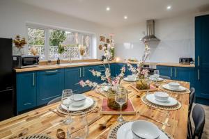 a kitchen with a wooden table and blue cabinets at 4 Bed in Brecon oc-h30823 in Brecon