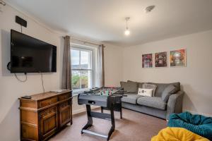 a living room with a couch and a table with a chessboard at 4 Bed in Brecon oc-h30823 in Brecon