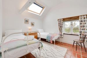 a room with two beds and a window at 3 Bed in Ridlington oc-2253 in Walcott