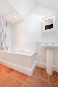 a bathroom with a bath tub and a sink at 3 Bed in Ridlington oc-2253 in Walcott +11 photos