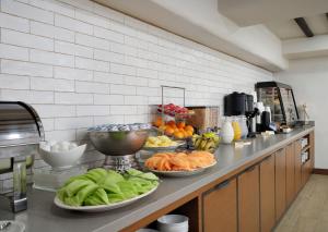 a kitchen with plates of fruits and vegetables on a counter at Hotel Pacific in Monterey