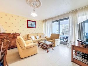 a living room with a couch and chairs and a table at Apartment Kérabus-3 by Interhome in Quiberon