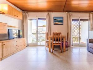 a living room with a table and a television at Apartment Delfines by Interhome in Cambrils